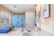 Bathroom showcasing a single sink vanity, decorative window, and blue turtle shower curtain at 5117 Spectacular Bid Dr, Wesley Chapel, FL 33544