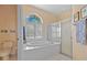 Bright bathroom with a large soaking tub, shower, and decorative window at 5117 Spectacular Bid Dr, Wesley Chapel, FL 33544