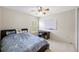 Bedroom with ceiling fan, window with blinds, desk, and whiteboard at 5117 Spectacular Bid Dr, Wesley Chapel, FL 33544