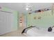 Bright bedroom featuring a ceiling fan, closet, and decorative shelf at 5117 Spectacular Bid Dr, Wesley Chapel, FL 33544