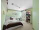 Cozy bedroom with a comfortable bed, desk, and a bookshelf with ample storage at 5117 Spectacular Bid Dr, Wesley Chapel, FL 33544