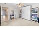 Bedroom with a ceiling fan, shelving units, murphy bed, and access to the hallway at 5117 Spectacular Bid Dr, Wesley Chapel, FL 33544