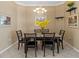 Formal dining room featuring neutral walls, tile floor, and contemporary chandelier at 5117 Spectacular Bid Dr, Wesley Chapel, FL 33544