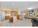 Open kitchen with island, adjacent living area, and modern appliances at 5117 Spectacular Bid Dr, Wesley Chapel, FL 33544
