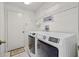 Laundry room equipped with a washer, dryer, and shelving at 5117 Spectacular Bid Dr, Wesley Chapel, FL 33544