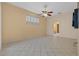 Empty living room with tile floors, a ceiling fan, and a view to an adjacent bathroom at 5117 Spectacular Bid Dr, Wesley Chapel, FL 33544