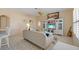 Cozy living room with tile flooring, comfortable seating, and entertainment center at 5117 Spectacular Bid Dr, Wesley Chapel, FL 33544