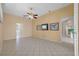Spacious living room with tile flooring, a ceiling fan, and large windows at 5117 Spectacular Bid Dr, Wesley Chapel, FL 33544