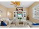 Comfortable living room with ceiling fan, entertainment center and natural light at 5117 Spectacular Bid Dr, Wesley Chapel, FL 33544