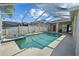 Relaxing screened pool and spa, with a lush tropical landscape and beautiful views at 5117 Spectacular Bid Dr, Wesley Chapel, FL 33544