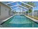 Enclosed in-ground pool and deck area featuring clear blue water at 5117 Spectacular Bid Dr, Wesley Chapel, FL 33544