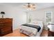Bedroom featuring a bed with wood flooring, dressers, and a ceiling fan at 5240 Westshore Dr, New Port Richey, FL 34652