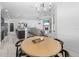 Open concept dining room with a chandelier, round table, and direct view to the kitchen and living areas at 595 Tierra Dr, Spring Hill, FL 34609