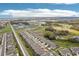 Beautiful aerial view of townhomes with a neighborhood pool and scenic views of the surrounding community and natural landscape at 6850 Ripple Pond Loop, Zephyrhills, FL 33541