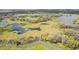 Scenic aerial view of a natural wetland area with a wooden walkway and beautiful landscape at 6850 Ripple Pond Loop, Zephyrhills, FL 33541