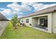 Private backyard with lush green grass, a covered patio, and a view of the landscaped perimeter at 6850 Ripple Pond Loop, Zephyrhills, FL 33541