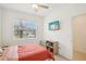 Cozy bedroom with a large window and TV, offering comfort and natural light at 6850 Ripple Pond Loop, Zephyrhills, FL 33541