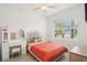 Charming bedroom features a vanity table and plush accents, offering comfort and style at 6850 Ripple Pond Loop, Zephyrhills, FL 33541