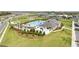 Community pool with lounge chairs and palms set in a Gathering-friendly location near tennis courts at 6850 Ripple Pond Loop, Zephyrhills, FL 33541