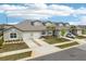 Well-maintained townhomes featuring garages, pristine landscaping, and paved driveways at 6850 Ripple Pond Loop, Zephyrhills, FL 33541