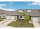 Charming townhome with attached garage, manicured lawn, and lovely landscaping at 6850 Ripple Pond Loop, Zephyrhills, FL 33541