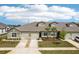 Beautiful townhome showcasing well-manicured landscaping and a welcoming facade with ample parking at 6850 Ripple Pond Loop, Zephyrhills, FL 33541