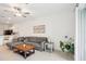 Spacious living room featuring tile flooring, modern decor, and an open layout at 6850 Ripple Pond Loop, Zephyrhills, FL 33541