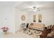 Welcoming living space featuring neutral tones, a ceiling fan, and tiled floors, blending style and comfort at 6850 Ripple Pond Loop, Zephyrhills, FL 33541