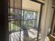 A screened-in balcony with a view of green space and mature trees at 700 Starkey Rd # 1525, Largo, FL 33771