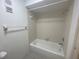 Clean and well-maintained bathroom with a bathtub and shower combo, and white tile at 700 Starkey Rd # 1525, Largo, FL 33771