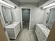 Bathroom featuring dual sinks with marble countertops and ornate mirrors, with a view to the toilet at 700 Starkey Rd # 1525, Largo, FL 33771