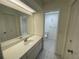 Bright bathroom with a long vanity, a spacious mirror, and a separate toilet room at 700 Starkey Rd # 1525, Largo, FL 33771