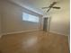 Bedroom featuring wood floors, ceiling fan, closet with folding doors, and a large window at 700 Starkey Rd # 1525, Largo, FL 33771