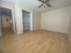Spacious bedroom boasts wood-look flooring, ceiling fan and an organized closet at 700 Starkey Rd # 1525, Largo, FL 33771