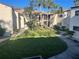 Well-maintained courtyard with green grass, trees, and walkways between the condo buildings at 700 Starkey Rd # 1525, Largo, FL 33771