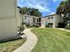 A well-maintained condo building with a landscaped lawn and inviting walkway at 700 Starkey Rd # 1525, Largo, FL 33771