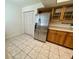 View of the kitchen featuring tile floors and a stainless steel refrigerator at 700 Starkey Rd # 1525, Largo, FL 33771