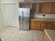 Kitchen featuring stainless steel appliances, wood cabinets, and neutral countertops at 700 Starkey Rd # 1525, Largo, FL 33771