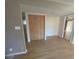 Living room featuring wood floors and a closet with wooden folding doors with a view to the balcony at 700 Starkey Rd # 1525, Largo, FL 33771