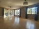 A bright living room with laminated floors, a ceiling fan, and large windows at 700 Starkey Rd # 1525, Largo, FL 33771