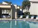 Community pool surrounded by lounge seating at 700 Starkey Rd # 1525, Largo, FL 33771
