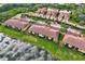 Wide aerial view of neighborhood homes nestled amongst lush greenery and serene ponds at 7305 River Hammock Dr # 204, Bradenton, FL 34212
