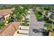 Lovely community aerial view showing palm trees lining street and tile roofs at 7305 River Hammock Dr # 204, Bradenton, FL 34212