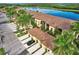 Scenic aerial view of townhomes backing onto a serene lake and lush greenery at 7305 River Hammock Dr # 204, Bradenton, FL 34212