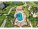 Aerial view of the community pool and lush tropical landscaping at 7305 River Hammock Dr # 204, Bradenton, FL 34212