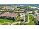 An aerial view of the community with mature landscaping, golf course, and a beautiful pool at 7305 River Hammock Dr # 204, Bradenton, FL 34212