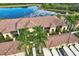 Stunning aerial view of residential buildings featuring a community pond and lush landscaping at 7305 River Hammock Dr # 204, Bradenton, FL 34212