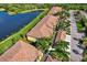 Wonderful aerial view of residential neighborhood featuring pond and lush landscaping at 7305 River Hammock Dr # 204, Bradenton, FL 34212