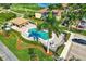 Aerial view of the community pool with people enjoying a swim and lounging by the pool at 7305 River Hammock Dr # 204, Bradenton, FL 34212