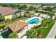 Aerial view of the pool with its inviting clear water, lounge chairs, and tables at 7305 River Hammock Dr # 204, Bradenton, FL 34212